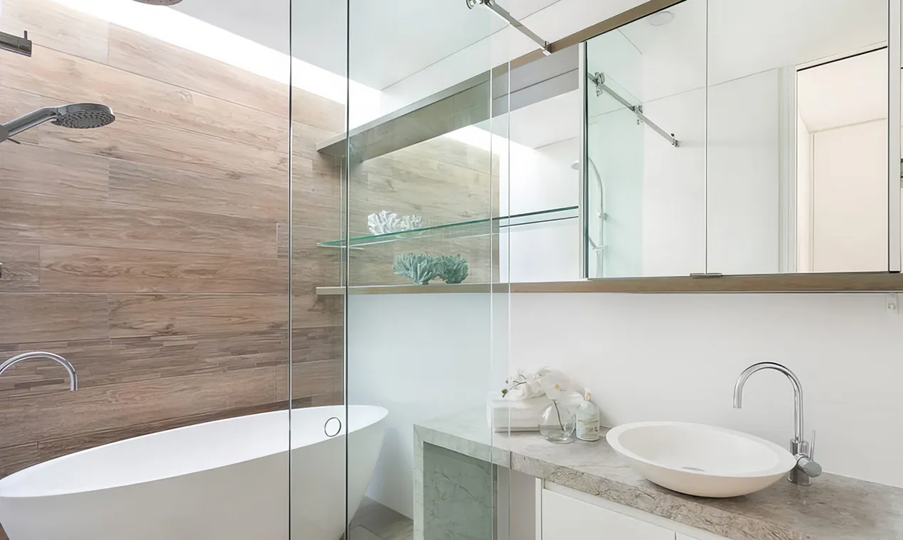 Contemporary bathroom in Blacktown featuring a freestanding bathtub, full glass shower, timber-look wall tiles, and sleek floating vanity with a vessel sink and mirrored cabinetry.