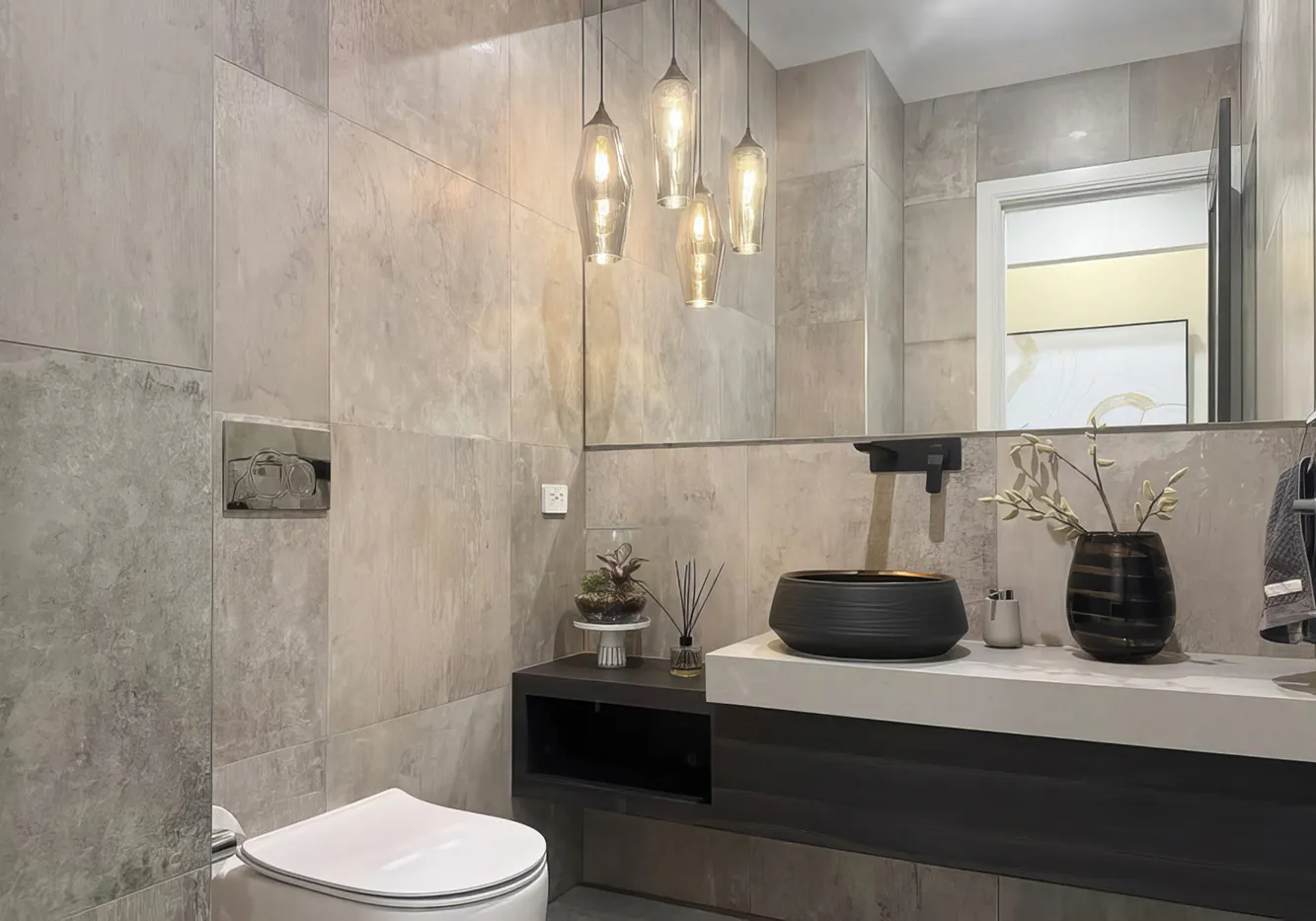 Elegant modern bathroom in Beaumont Hills featuring a black vessel basin, wall-mounted tapware, stone-look tiles, pendant lighting, and a floating vanity for a contemporary finish.